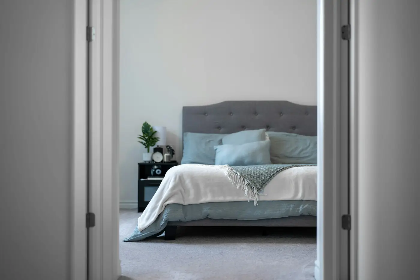 Made bed in a bright bedroom