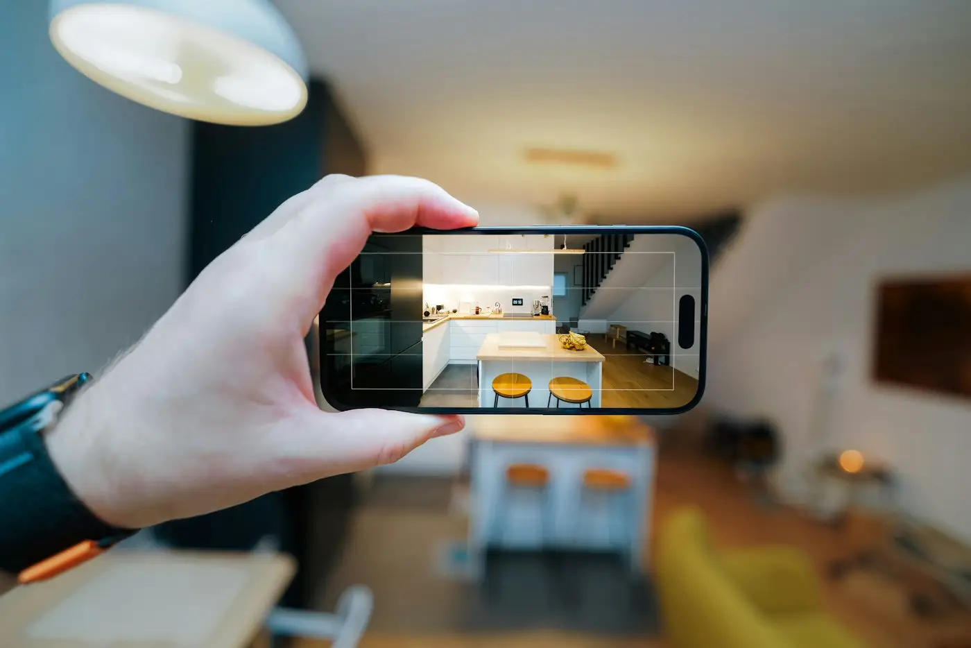 Person photographing a living room